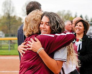 Alicia Saxton, right, a senior on the Boardman softball team, hugs school district Athletic Director Denise Gorski during senior night at the newly renovated  softball field.  The parents of players worked two weekends to install a new wind screen and work on the field’s surface and drainage.  
