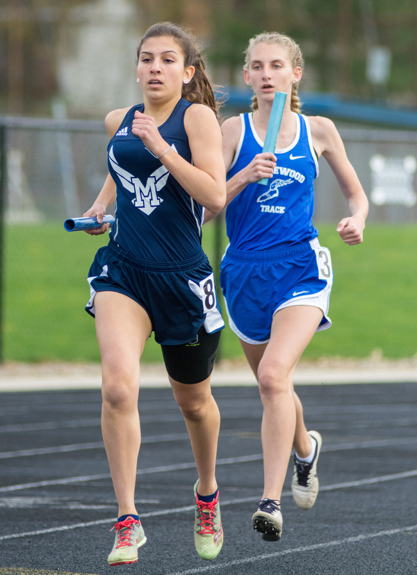 Sela Jones of McDonald outpaces Marissa Ventura of Maplewood in the 3,200-meter relay at the Trumbull County Track and Field Meet on Tuesday.