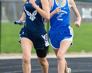 Sela Jones of McDonald outpaces Marissa Ventura of Maplewood in the 3,200-meter relay at the Trumbull County Track and Field Meet on Tuesday.