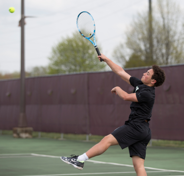 Ursuline's Greg Morgione hits the ball back to Boardman's Justin Olsen during their match at Boardman on Wednesday. EMILY MATTHEWS | THE VINDICATOR