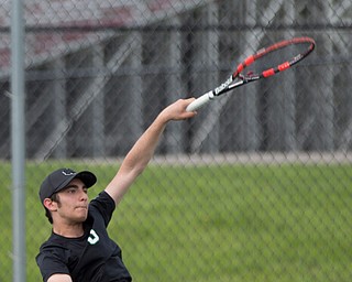 Ursuline's Josh Khavari hits the ball back to Boardman's Carter Mascola and Ryder Kreps during their doubles match at Boardman on Wednesday. EMILY MATTHEWS | THE VINDICATOR