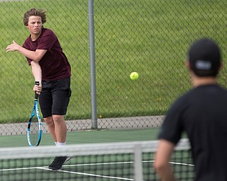 Boardman's Ryder Kreps hits the ball back to Ursuline's Josh Khavari and Gavin Blacksher during their doubles match at Boardman on Wednesday. EMILY MATTHEWS | THE VINDICATOR