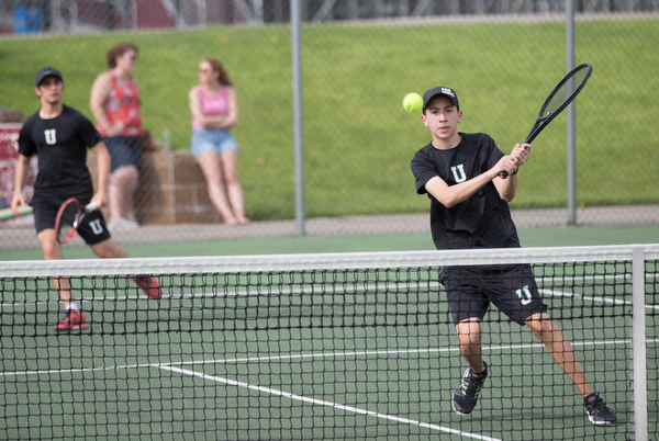 Ursuline's Gavin Blacksher hits the ball during a doubles match with teammate Josh Khavari against Boardman's Carter Mascola and Ryder Kreps at Boardman on Wednesday. EMILY MATTHEWS | THE VINDICATOR