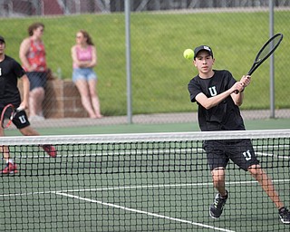 Ursuline's Gavin Blacksher hits the ball during a doubles match with teammate Josh Khavari against Boardman's Carter Mascola and Ryder Kreps at Boardman on Wednesday. EMILY MATTHEWS | THE VINDICATOR