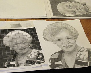 Neighbors | Jessica Harker.Community members used photos of loved ones to draw potraits April 2 for the second Potrait Drawing class hosted at the Austintown library.