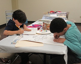 Neighbors | Jessica Harker.Gavin Anderson and Trey Burkey worked to trace animals and cars for their own storyboards on April 19 at the Boardman library's Felt Fun event.