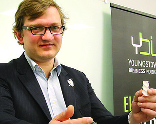 The Youngstown Business Incubator announced that Nanoe, a France-based company, will be operating out of the incubator as it explores expanding its business to the United States. Guillaume de Calan, Nanoe CEO, shows two of the filaments that the company creates with its materials and 3D printing machine.