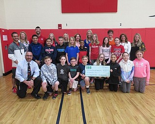 Neighbors | Jessica Harker.Austintown Intermediate School staff and student participants in the annual basketball game posed with a check for more than $2,000 that were raised during the game for the Rescue Mission of the Mahoning Valley.