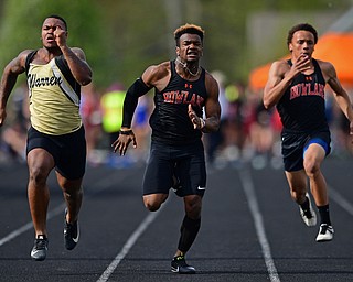 CORTLAND, OHIO - MAY 2, 2019: Howland's William Hines, center, races to the finish line against Michael Wilson and Harding's Michael Wilson during the boys 100 meter dash, Thursday afternoon during the Trumbull County Track Meet at Lakeview High School. DAVID DERMER | THE VINDICATOR