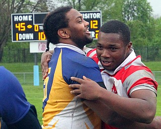 William D. Lewis The Vindicator  East's Turhan Henderson(5) and Chaney'sTerrance Love hug afterEast defeated Chaney 45-12 at Rayen Stadium 5-3-19.