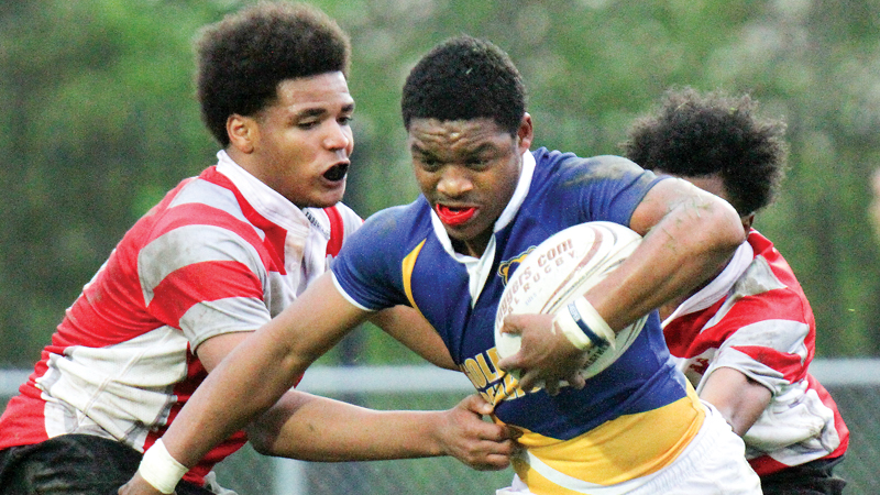 East’s Vincent Steele, right, eludes Chaney’s RaShawn Perkins during their match at Rayen Stadium on Friday. Perkins helped lead the Golden Bears to a 45-12 win and an undefeated season.