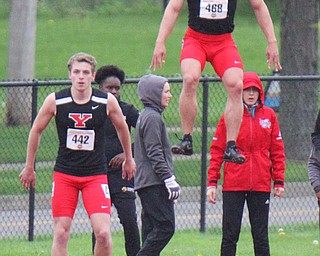 William D. Lewis The Vindicator YSU's Chad Zallow jumps high while warming up for 100 . at left is Brendan Lucas.