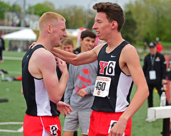 YOUNGSTOWN, OHIO - MAY 5, 2019: Youngstown State's Sean Peterson, is hugged by Cole Lovett after winning the Men's 800 meter, Sunday afternoon during the Horizon League Outdoor Track Championship at the Youngstown State Sports Complex. DAVID DERMER | THE VINDICATOR
