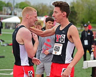 YOUNGSTOWN, OHIO - MAY 5, 2019: Youngstown State's Sean Peterson, is hugged by Cole Lovett after winning the Men's 800 meter, Sunday afternoon during the Horizon League Outdoor Track Championship at the Youngstown State Sports Complex. DAVID DERMER | THE VINDICATOR