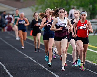 Boardman's Raegan Burkey, left, and Canfield's Ashley Ventimiglia push for the lead during the Girls 1600 Meter Run at the All-American Conference Red Tier High School Track Championships at Austintown Fitch Greenwood Chevrolet Falcon Stadium on Tuesday. EMILY MATTHEWS | THE VINDICATOR