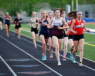 Boardman's Raegan Burkey, left, and Canfield's Ashley Ventimiglia push for the lead during the Girls 1600 Meter Run at the All-American Conference Red Tier High School Track Championships at Austintown Fitch Greenwood Chevrolet Falcon Stadium on Tuesday. EMILY MATTHEWS | THE VINDICATOR