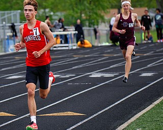 Canfield's Giovanni Copploe keeps his lead with Boardman's Mitchel Dunham behind him during the Boys 1600 Meter Run at the All-American Conference Red Tier High School Track Championships at Austintown Fitch Greenwood Chevrolet Falcon Stadium on Tuesday. EMILY MATTHEWS | THE VINDICATOR