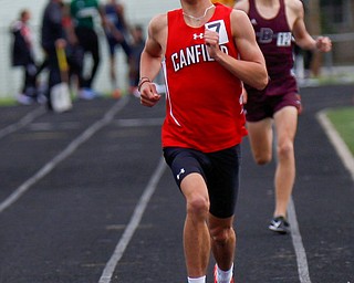 Canfield's Giovanni Copploe keeps his lead with Boardman's Mitchel Dunham behind him during the Boys 1600 Meter Run at the All-American Conference Red Tier High School Track Championships at Austintown Fitch Greenwood Chevrolet Falcon Stadium on Tuesday. EMILY MATTHEWS | THE VINDICATOR