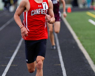 Canfield's Giovanni Copploe keeps his lead with Boardman's Mitchel Dunham behind him during the Boys 1600 Meter Run at the All-American Conference Red Tier High School Track Championships at Austintown Fitch Greenwood Chevrolet Falcon Stadium on Tuesday. EMILY MATTHEWS | THE VINDICATOR