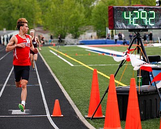 Canfield's Giovanni Copploe finishes in first for the Boys 1600 Meter Run at the All-American Conference Red Tier High School Track Championships at Austintown Fitch Greenwood Chevrolet Falcon Stadium on Tuesday. EMILY MATTHEWS | THE VINDICATOR