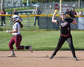 Canfield's Liz Ferraro throws the ball to first while Boardman's Nadia Rawhneh runs past her to get to third during their game on Wednesday. Boardman won 6-0. EMILY MATTHEWS | THE VINDICATOR