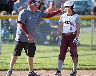 Boardman's head coach Fred Mootz pats Dana Haus on the helmet after she makes it to third during their game against Canfield on Wednesday. Boardman won 6-0. EMILY MATTHEWS | THE VINDICATOR