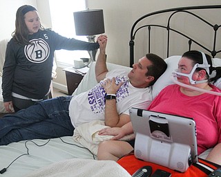 William D. Lewis The Vindicator  Christine Terlesky , who has ALS, shares a moment with her husband Brian in their Boardman home 4-4-19. Daughter Emma is at left.
