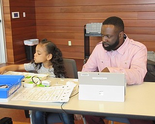 Neighbors | Jessica Harker .Ava Wise with the help of her father Lorenzo Wise II constructed a Lego robot at the Michael Kusalaba library's Lego WeDo Robots event April 18.
