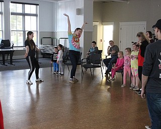 Neighbors | Abby Slanker.Canfield High School seniors and National Honor Society members Isabella Audia (left) and Mariah Cashbaugh had a Spring Sing at the Canfield library on April 13, during which they led chidlren in singing Disney songs..