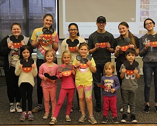 Neighbors | Abby Slanker.Canfield High School seniors and National Honor Society members Isabella Audia and Mariah Cashbaugh (back right) were joined by fellow CHS students and sing-a-long participants as they showed off the craft they made at the Spring Sing at the Canfield library on April 13.