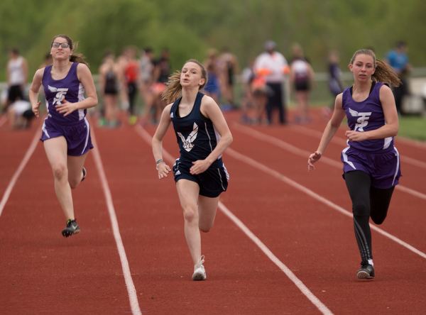 From left, Seb. McKinley's Mary Quinn, McDonald's Anastasia Christiansen, and Seb. McKinley's Kalyn Mudrick compete in the first section of the Girls 100 Meter Dash at the Mahoning Valley Athletic Conference High School League Championship Meet at Western Reserve High School on Thursday. Christiansen finished in first. EMILY MATTHEWS | THE VINDICATOR
