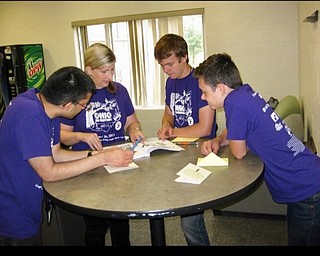 Neighbors | Submitted.Boardman advanced biology teacher and Envirothon coach Heather Moran looked up trees along with students Justin Olsen and Bryson Harris during the Envirothon competition on April 25.