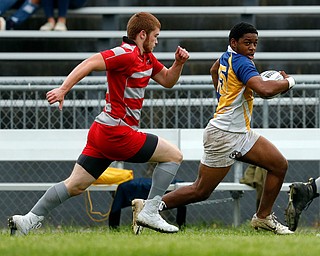YOUNGSTOWN, OHIO - May 10, 2019: Rugby- Northwest Indians vs East Golden Bears.  East Golden Bears' Vincent Steele (yellow, 15) runs for a long gain during the 1st half at Rayen Stadium.  Photo by MICHAEL G. TAYLOR | THE VINDICATOR