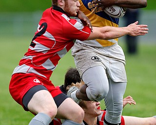 YOUNGSTOWN, OHIO - May 10, 2019: Rugby- Northwest Indians vs East Golden Bears.  East Golden Bears' Jarall Jenkins (10, right) still arms Northwest Indians' Dean Hutzell (2) during the 1st half at Rayen Stadium. Photo by MICHAEL G. TAYLOR | THE VINDICATOR