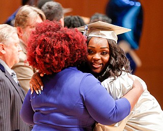 Kaia Anderson, right, hugs Monica James, the dean of Youngstown Rayen Early College, as she receives her diploma during the Class of 2019 commencement ceremony Friday in Ford Recital Hall at DeYor Performing Arts Center downtown. 