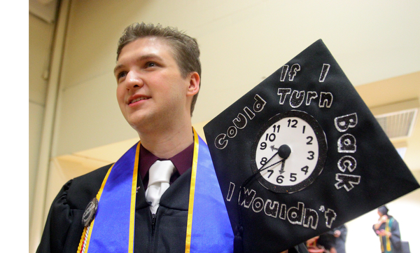 William D. Lewis the Vindicator  YSU grad Billy Blaze of Hermitage shows off a message he placed on his cap.