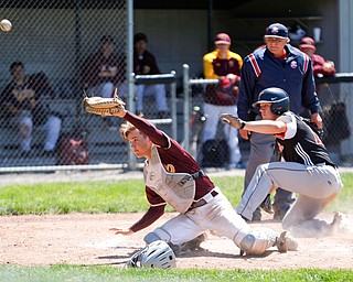 The ball gets past South Range catcher's Trey Pancake as Springfield's Shane Eynon slides in to score during their game on Saturday at Springfield High School. Springfield won in the 10th inning 9-8. EMILY MATTHEWS | THE VINDICATOR