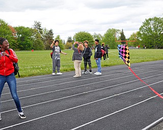 Alaja Johnson, 17, an 11th grader at Chaney High School, flies a kite during a fundraiser for Save the Children, an organization that helps child refugees, on the track at Chaney High School on Tuesday afternoon. EMILY MATTHEWS | THE VINDICATOR