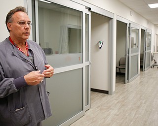 Mark Paczak, a registered nurse and the director of pain management in the new Southwoods Pain and Spine Center, talks about how the fogged doors of patients' rooms provide patients with privacy on Monday morning. EMILY MATTHEWS | THE VINDICATOR