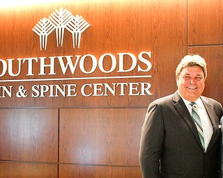 Southwoods Health CEO Ed Muransky, left, and Josh Thompson, Muransky Co.’s head of construction, pose in the reception area of the new Southwoods Pain and Spine Center in Boardman.
