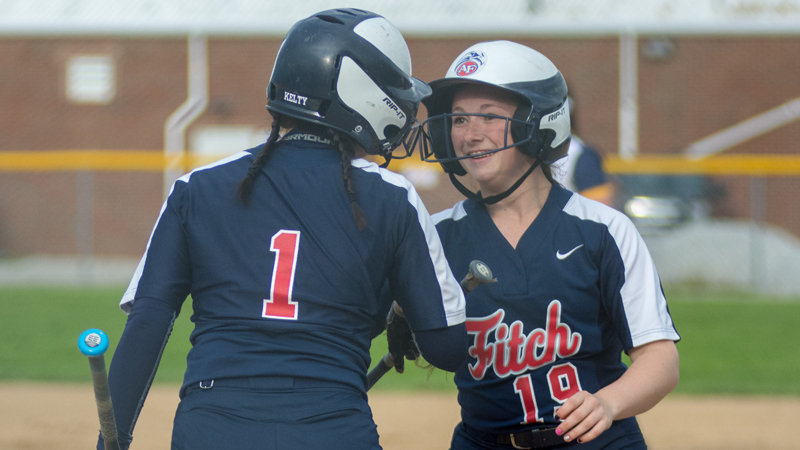 Abby Brown of Austintown Fitch, right, is all smiles as Kayla Kelty congratulates her after doubling and scoring a run against Solon in a Division I district semifinal at Roxbury Field in Solon on Wednesday.
