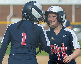 Abby Brown of Austintown Fitch, right, is all smiles as Kayla Kelty congratulates her after doubling and scoring a run against Solon in a Division I district semifinal at Roxbury Field in Solon on Wednesday.
