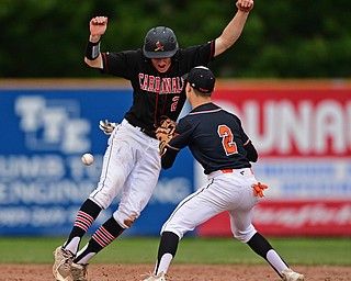 STRUTHERS, OHIO - MAY 15, 2019: Howland's Gage Tomko loses possession of the ball while attempting to tag out Canfield's Brent Herrmann after he was caught in a rundown in the second inning of Wednesday nights OHSAA Tournament game at Cene Park. DAVID DERMER | THE VINDICATOR