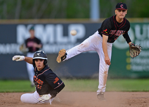 STRUTHERS, OHIO - MAY 15, 2019: Canfield's Michael Buddle, right, looks to first after forcing out Howland's Joey Peefelte at second base in the third inning of Wednesday nights OHSAA Tournament game at Cene Park. The Howland runner would be ace at first base. DAVID DERMER | THE VINDICATOR