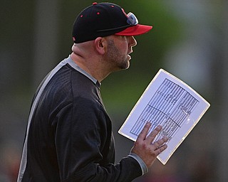 STRUTHERS, OHIO - MAY 15, 2019: Canfield head coach Gary Knittle talks near the dugout in the fourth inning of Wednesday nights OHSAA Tournament game at Cene Park. The Howland runner would be ace at first base. DAVID DERMER | THE VINDICATOR