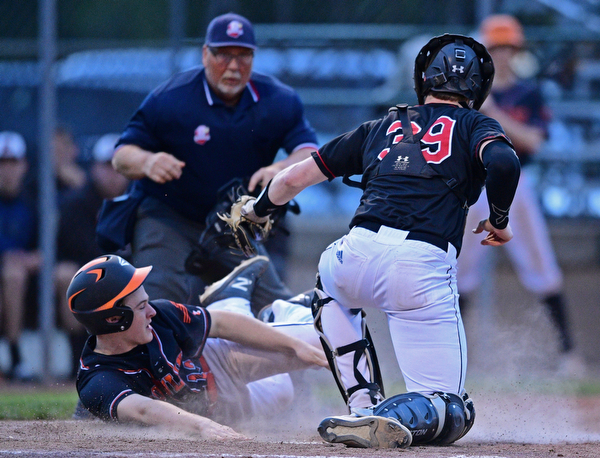 STRUTHERS, OHIO - MAY 15, 2019: Howland's Ian Meekel is tagged out by Canfield's Danny Beistel in the fourth inning of Wednesday nights OHSAA Tournament game at Cene Park. The Howland runner would be ace at first base. DAVID DERMER | THE VINDICATOR
