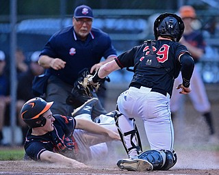 STRUTHERS, OHIO - MAY 15, 2019: Howland's Ian Meekel is tagged out by Canfield's Danny Beistel in the fourth inning of Wednesday nights OHSAA Tournament game at Cene Park. The Howland runner would be ace at first base. DAVID DERMER | THE VINDICATOR