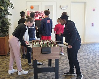 Neighbors | Jessica Harker.Austintown students played foosball at the Austintown library on April 22 during the library's after school program.