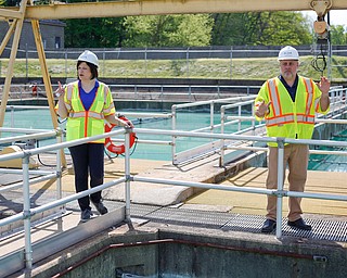 Jennifer Johnson, left, area manager at Aqua Ohio, and George Ginnis, project manager at Aqua Ohio, discuss progress on the renovations near the sedimentation basins at the Aqua Ohio water plant in Poland on Thursday morning. The sedimentation basins will be replaced by a new solid contact unit. EMILY MATTHEWS | THE VINDICATOR