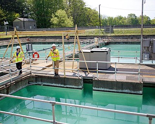 Jennifer Johnson, left, area manager at Aqua Ohio, and George Ginnis, project manager at Aqua Ohio, discuss progress on the renovations near the sedimentation basins at the Aqua Ohio water plant in Poland on Thursday morning. The sedimentation basins will be replaced by a new solid contact unit. EMILY MATTHEWS | THE VINDICATOR
